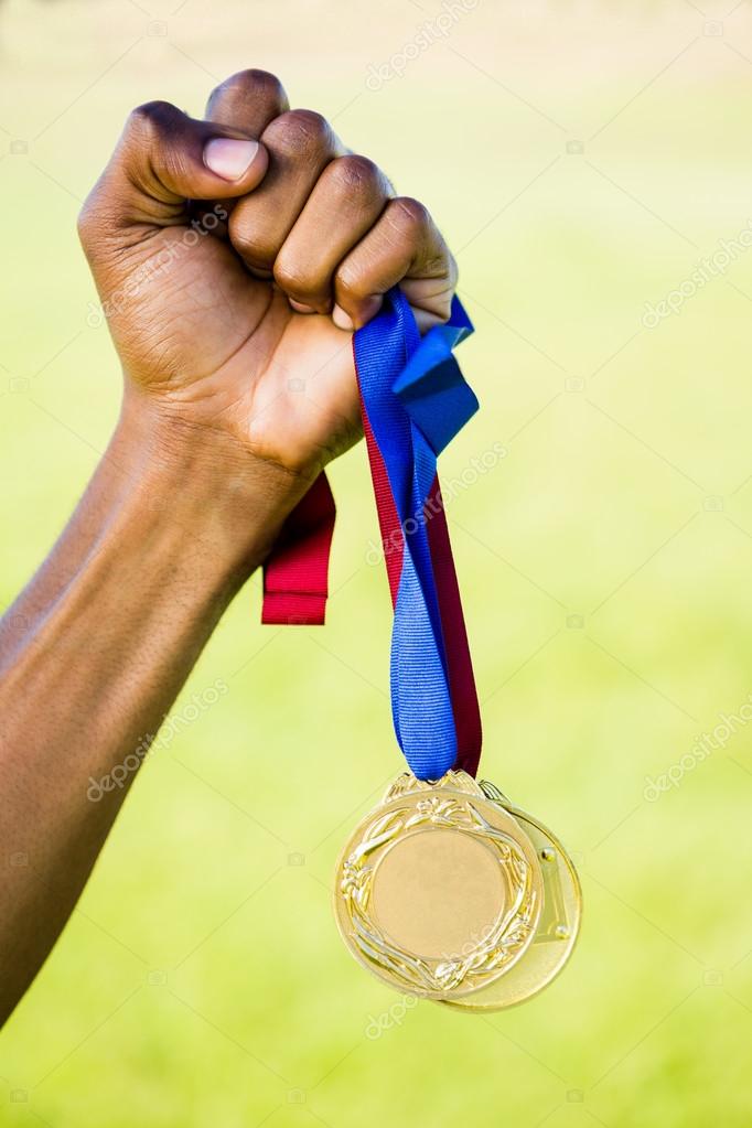Athletes hand holding gold medal — Stock Photo © Wavebreakmedia 110809214