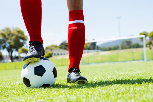 Football player with feet on ball — Stock Photo, Image
