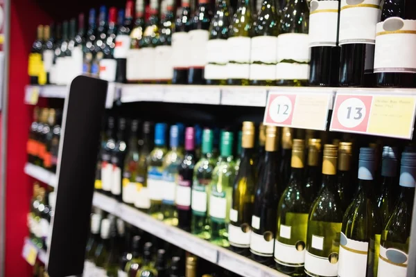 Focus on wine bottle shelf — Stock Photo, Image