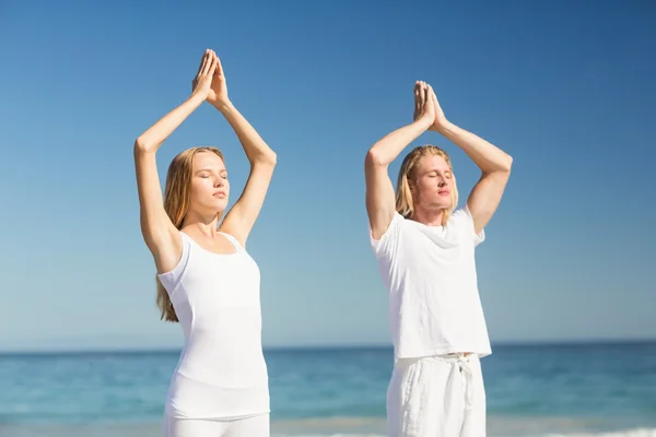 Man and woman performing yoga — Stock Photo, Image