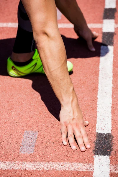 Athletes hands on starting block — Stock Photo, Image