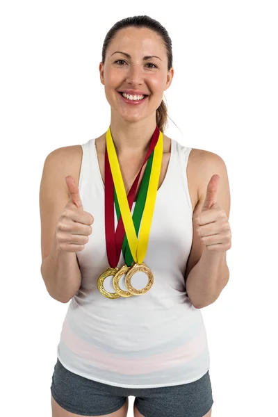 Athlete posing with gold medals — Stock Photo, Image