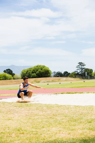 Sandpit üzerinde açılış atlet — Stok fotoğraf