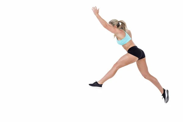 Atleta feminina pulando — Fotografia de Stock