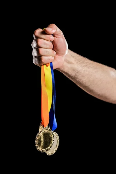 Hand holding olympic gold medals — Stock Photo, Image