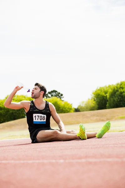 Tired athlete drinking water — Stock Photo, Image