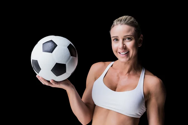 Female athlete holding soccer ball — Stock Photo, Image