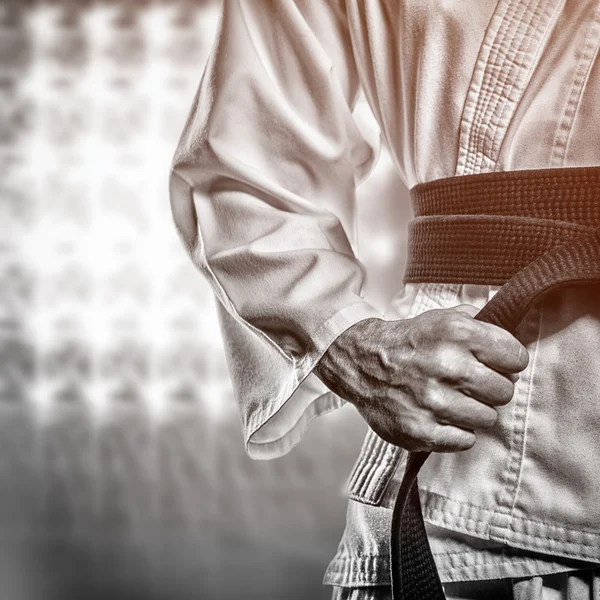 Fighter tightening karate belt — Stock Photo, Image