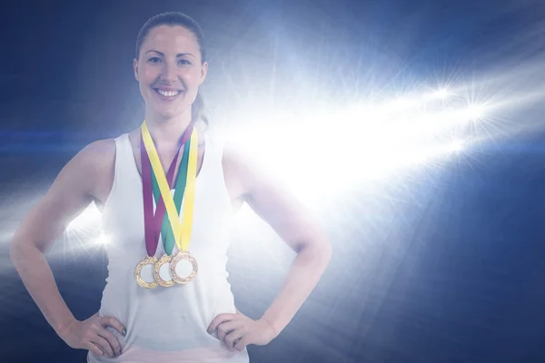 Athlete posing with gold medals — Stock Photo, Image