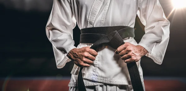 Fighter tightening karate belt — Stock Photo, Image