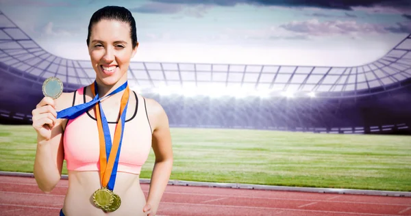 Sportswoman showing her medals — Stock Photo, Image