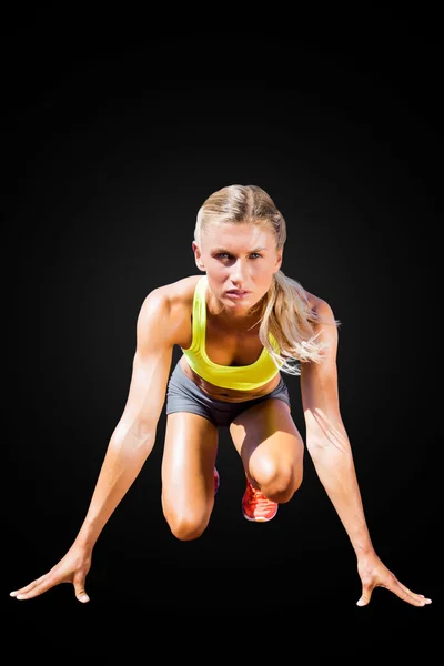 Sportswoman in the starting block — Stock Photo, Image