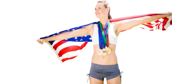 Sportswoman with medals holding american flag — Stock Photo, Image