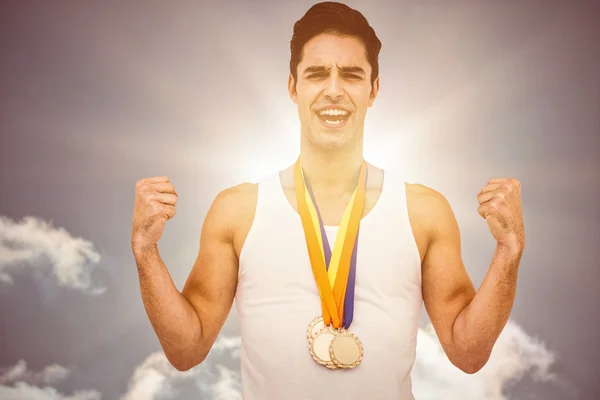 Athlete posing with gold medals — Stock Photo, Image