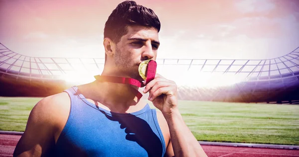 Sportsman kissing a medal — Stock Photo, Image