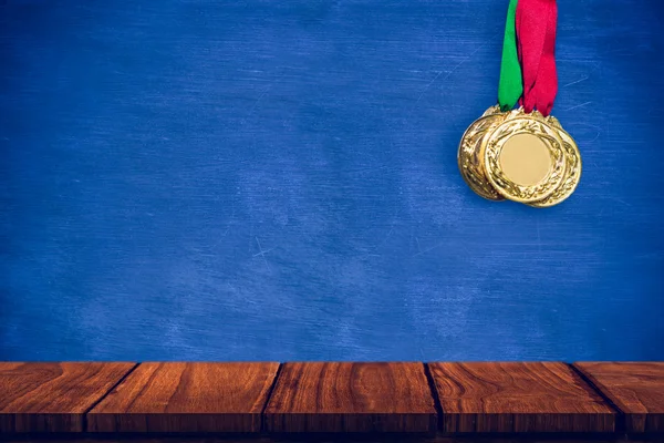 Gold medals against blue background — Stock Photo, Image