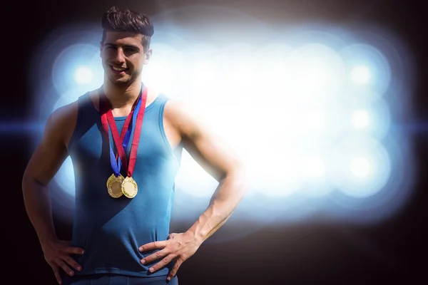 Athletic man holding medals — Stock Photo, Image