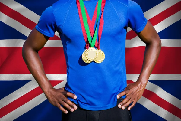 Athletic man chest holding gold medals — Stock Photo, Image
