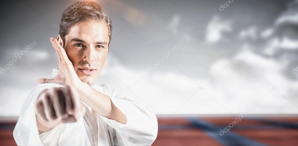 Fighter performing karate stance Stock Photo by ©Wavebreakmedia 111733426