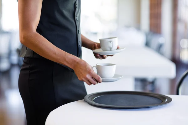 Waitress serving cup of coffee — Stock Photo, Image