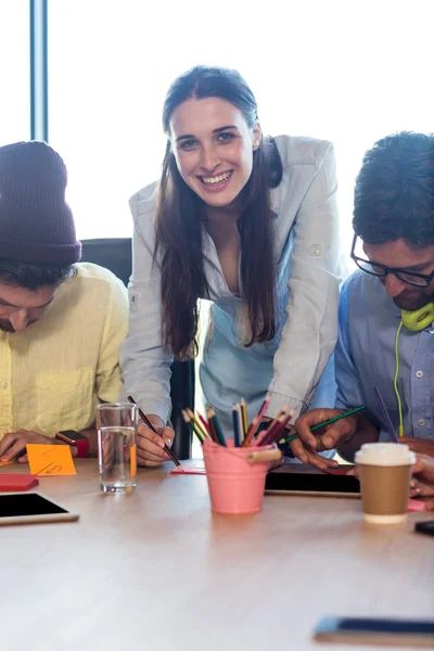 Businesswoman with colleagues in office — Stock Photo, Image