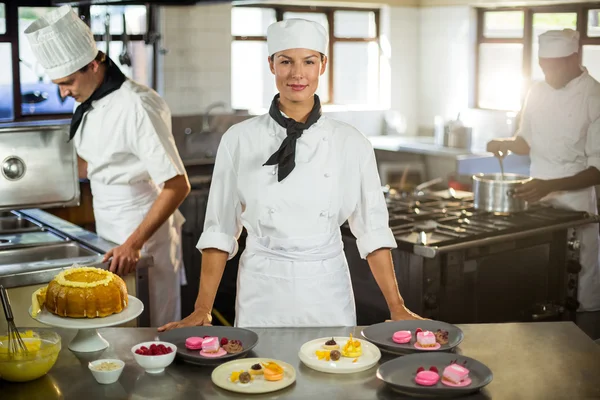 Female chef presenting dessert plates — Stock Photo, Image