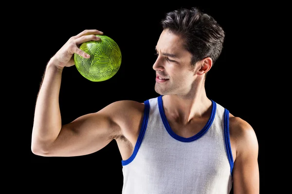 Happy male athlete holding a ball — Stock Photo, Image