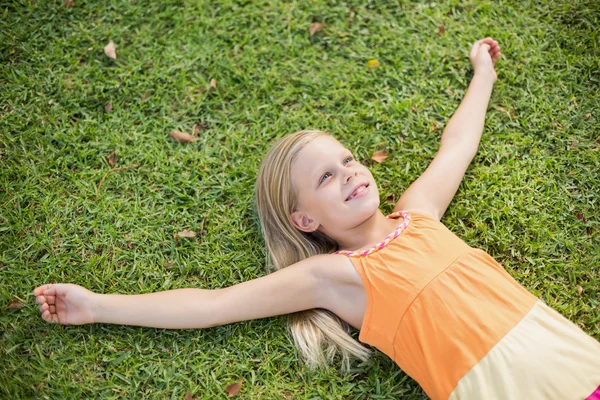 Jong meisje liggen op gras — Stockfoto