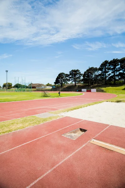 Long jump sand pit on running track — Stock Photo, Image