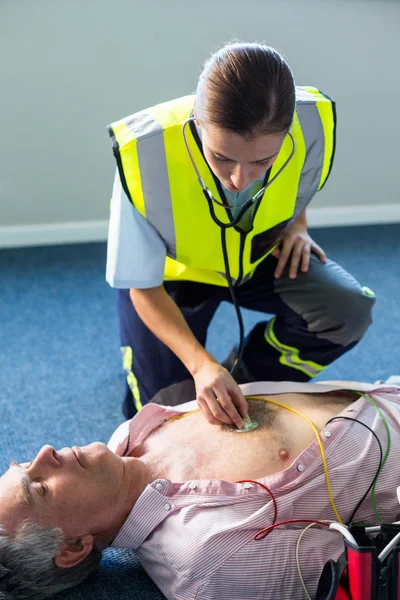 Paramédico examinando um paciente — Fotografia de Stock