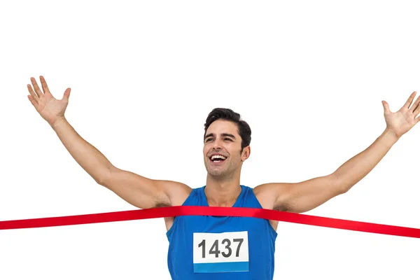 Vrolijke winnaar atleet kruising finishlijn — Stockfoto