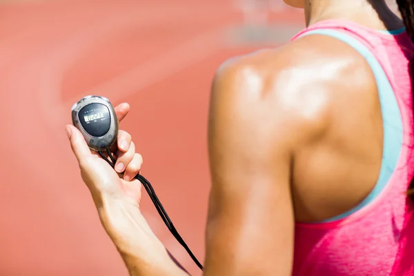 Female athlete using stopwatch — Stock Photo, Image