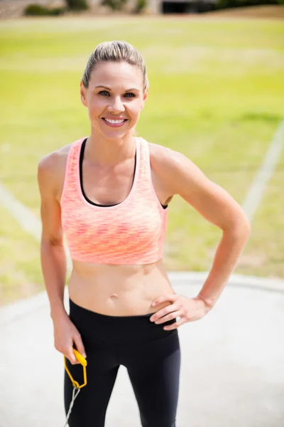 Portrait of female athlete standing with hands on hips — Stock Photo, Image