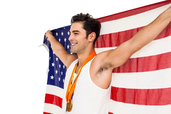 Спортсмен позирует с золотыми медалями после победы — стоковое фото