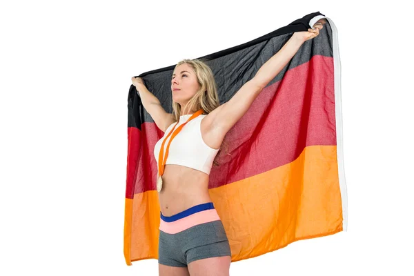 Athlet posiert nach Sieg mit deutscher Fahne — Stockfoto