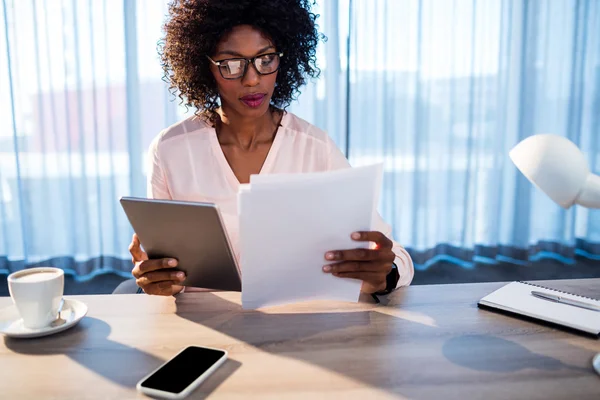 Geschäftsfrau hält Tablet in der Hand und liest ein Dokument — Stockfoto