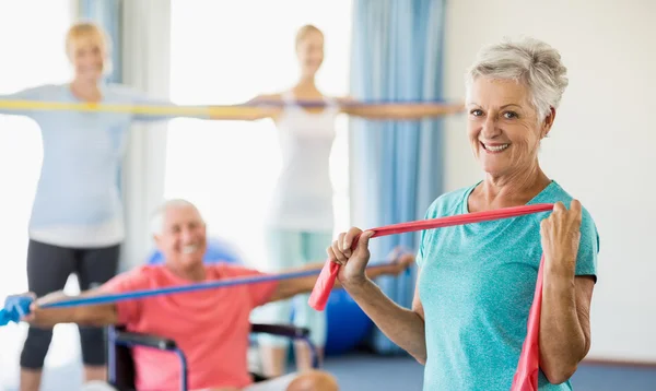 Seniors exercising with stretching bands — Stock Photo, Image