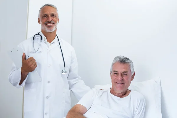 Portrait of happy male doctor and senior man — Stok Foto