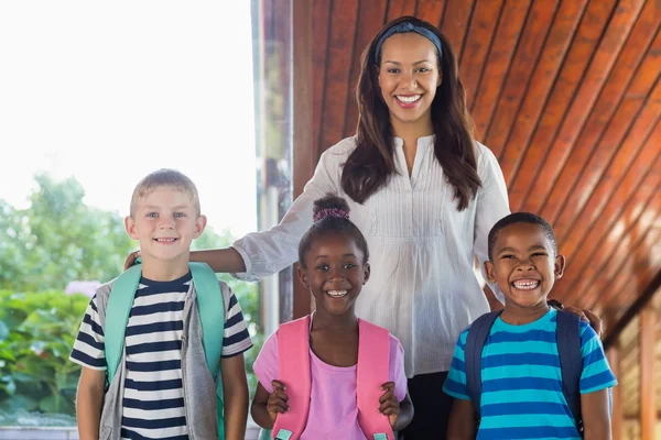 Smiling teacher and kids — Stock Photo, Image