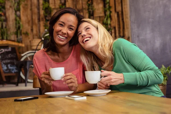 Friends holding a cup of coffee — Stock Photo, Image