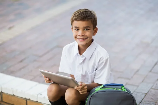 Schoolboy in campus using tablet — Stock Photo, Image