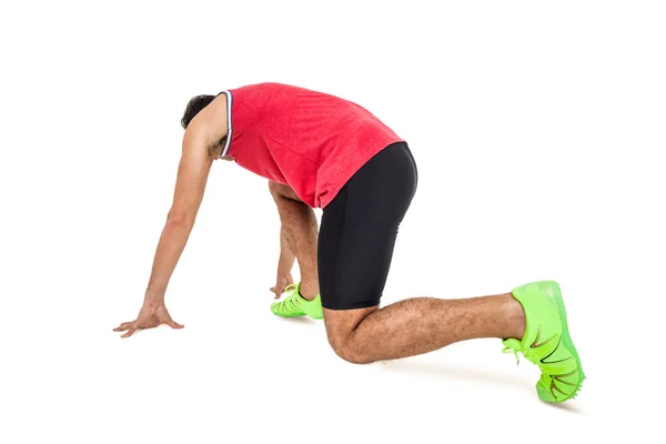 Mannelijke atleet in klaar positie uitvoeren — Stockfoto