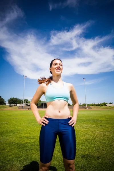 Atleta feminina confiante de pé com a mão no quadril — Fotografia de Stock