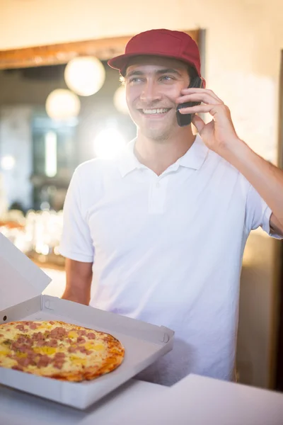 Pizza delivery man taking an order — Stock Photo, Image