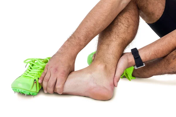 Male athlete with foot pain on white background — Stock Photo, Image