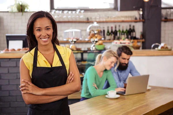 Waitress standing with arms crossed — Stock Photo, Image