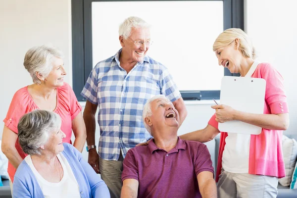 Anziani e infermiera ridono insieme — Foto Stock