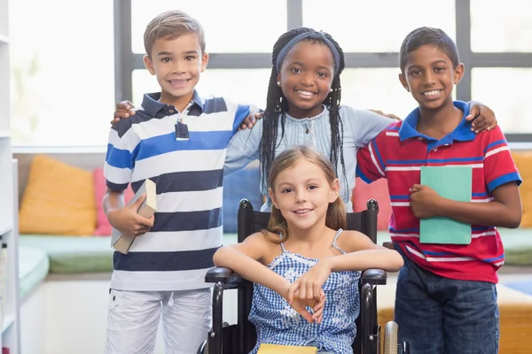 Bambini della scuola in piedi in biblioteca — Foto Stock