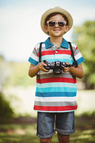 Boy in sunglasses holding a camera — Stock Photo, Image