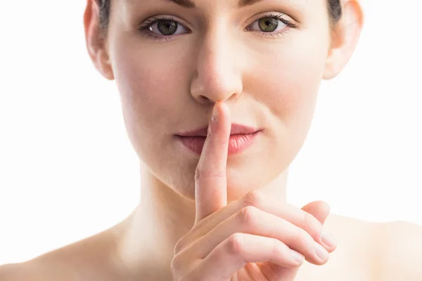 Woman with her finger on mouth — Stock Photo, Image